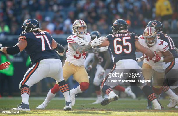 Cody Whitehair of the Chicago Bears blocks Cassius Marsh and Solomon Thomas of the San Francisco 49ers during the game at Soldier Field on December...