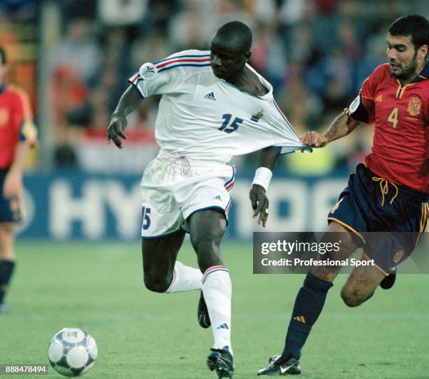 Lilian Thuram of France gets his shirt pulled by Pep Guardiola of Spain during the UEFA Euro 2000 Quarter Final at the Jan Breydel Stadium on June...