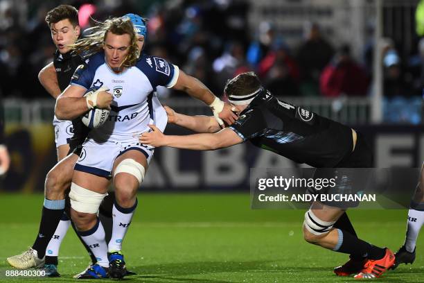 Montpellier's South African lock Jacques Du Plessis is tackled by Glasgow Warriors' Scottish lock Scott Cummings during the European Champions Cup...