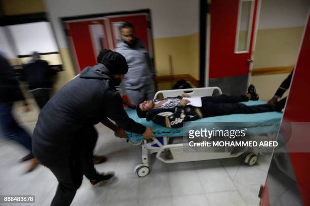 An injured Palestinian man arrives at a hospital to receive treatment following an Israeli air strike in Beit Lahia, in the northern Gaza Strip, on...