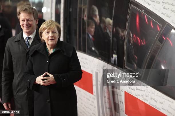 German Chancellor Angela Merkel poses with Deutsche Bahn CEO Richard Lutz at the Berlin central train station or Hauptbahnhof with the ICE...