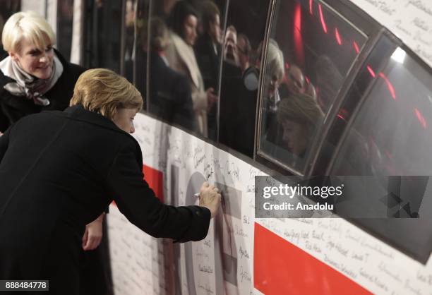 German Chancellor Angela Merkel , signs the ICE Inter-City-Express Train during the first journey of the high speed track that connect the German's...