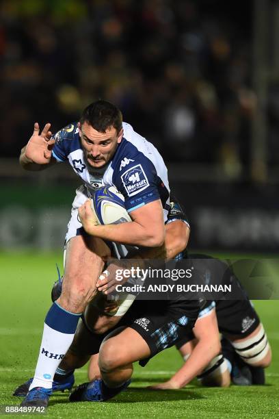 Montpellier's French number 8 Louis Picamoles is tackled during the European Champions Cup pool 3 rugby union match between Glasgow Warriors and...