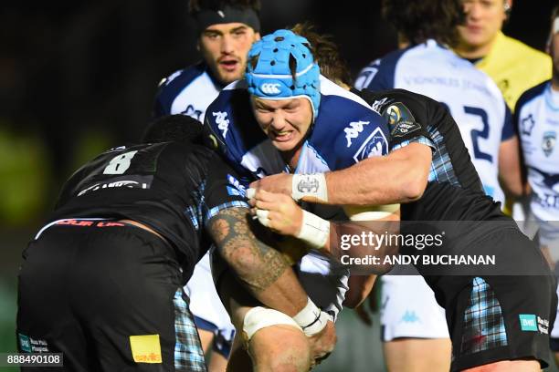 Montpellier's South African lock Nicolaas Janse van Rensburg is tackled during the European Champions Cup pool 3 rugby union match between Glasgow...