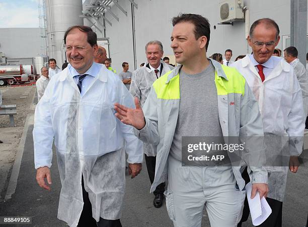 French Secretary of State for Industry, Artisan Trades, Small and Medium-Sized Businesses, Tourism, and Services Herve Novelli listens to Michel...