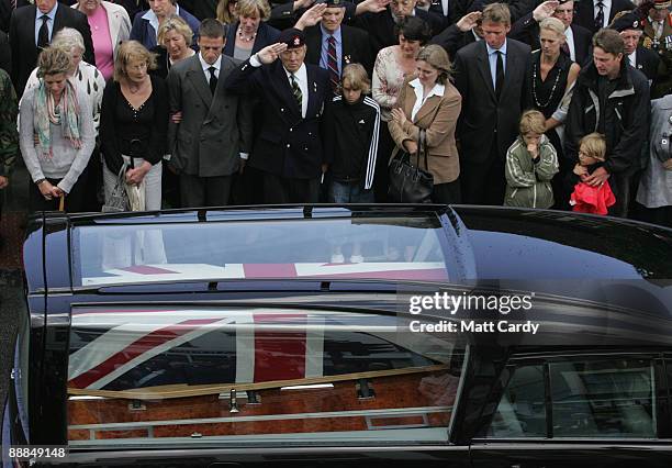 People watch as the hearse carrying the coffin of Lieutenant-Colonel Rupert Thorneloe, aged 39, follows that of Trooper Josh Hammond, aged 18, as...