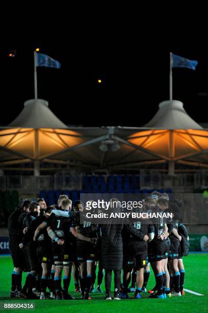 Glasgow players form a group huddle on the pitch after the European Champions Cup pool 3 rugby union match between Glasgow Warriors and Montpellier...