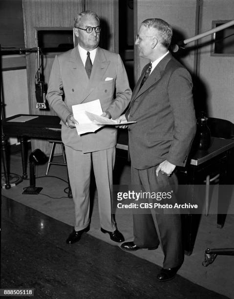 Herbert E. Smith, President of U.S. Rubber Company, part sponsor of CBS Radio broadcasts of the New York Philharmonic Orchestra talks with Harvey...