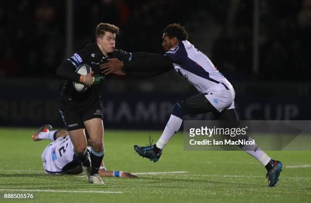 Huw Jones of Glasgow Warriors pushes away Jan Serfontein of Montpellier during the European Rugby Champions Cup match between Glasgow Warriors and...
