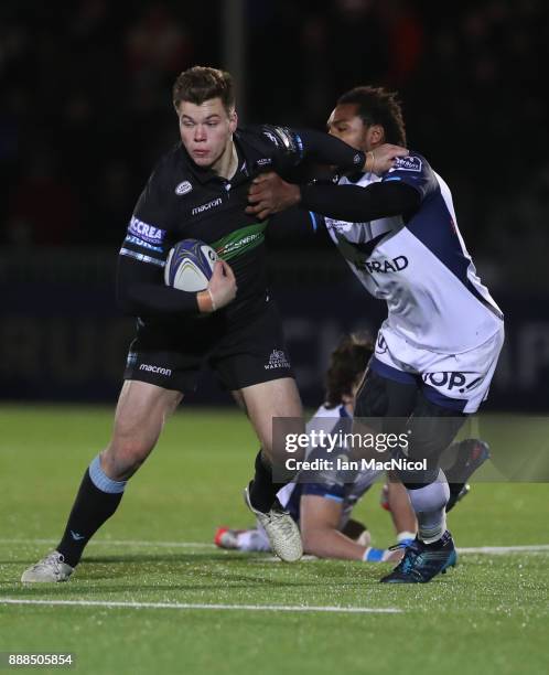 Huw Jones of Glasgow Warriors pushes away Jan Serfontein of Montpellier during the European Rugby Champions Cup match between Glasgow Warriors and...