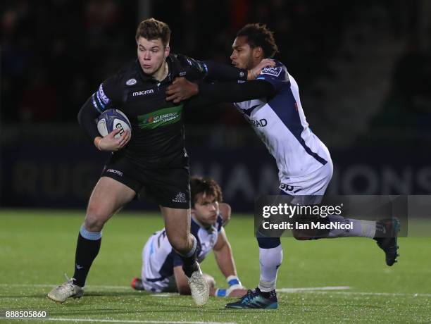 Huw Jones of Glasgow Warriors pushes away Jan Serfontein of Montpellier during the European Rugby Champions Cup match between Glasgow Warriors and...
