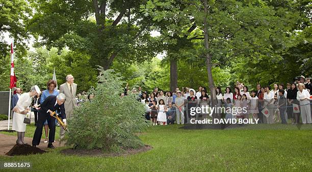 Japan's Emperor Akihito and Empress Michiko plant a tree on the grounds of Rideau Hall with Micha�lle Jean Governor General of Canada at Rideau Hall...