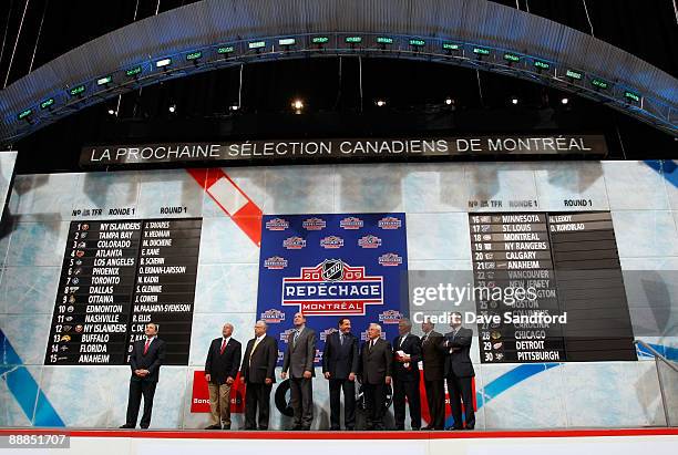 Members of the Montreal Canadiens organization look on from the podium prior to making the 18th overall selection for their first pick in the first...