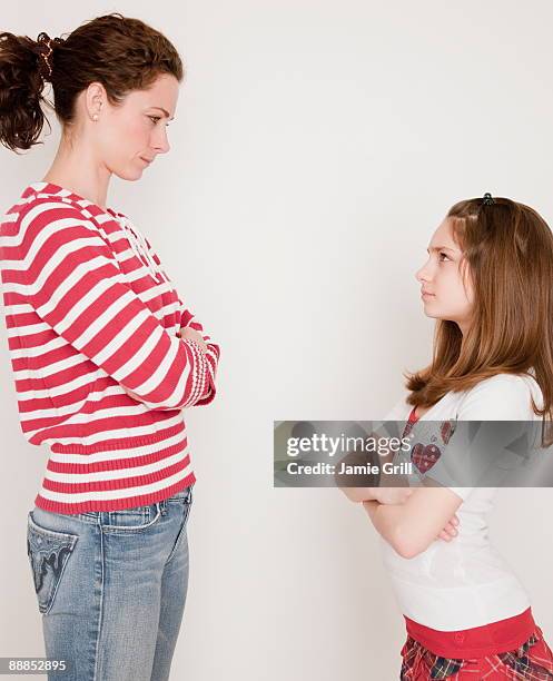 mother and daughter (10-11 years) having argument, standing face to face - kids arguing stock pictures, royalty-free photos & images