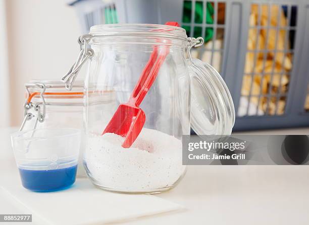detergent and washing powder by laundry basket - detergent powder stock pictures, royalty-free photos & images