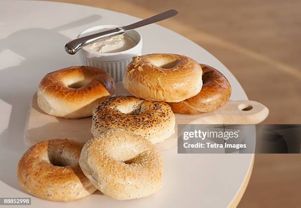 bagels and cream cheese on table - bagels stock pictures, royalty-free photos & images