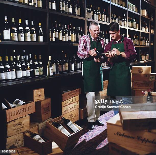 father and son in liquor store - bottle shop stock pictures, royalty-free photos & images
