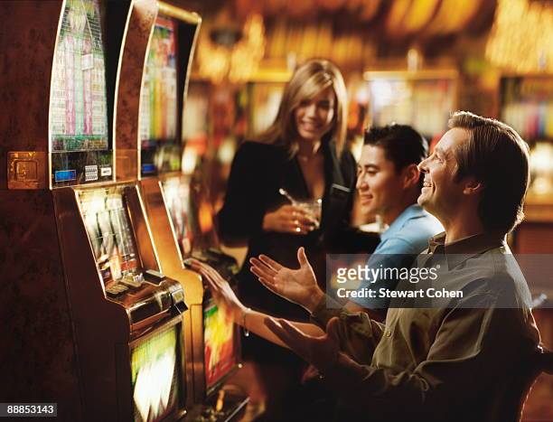 usa, nevada, las vegas, people in casino playing on slot machines - slot machine bildbanksfoton och bilder
