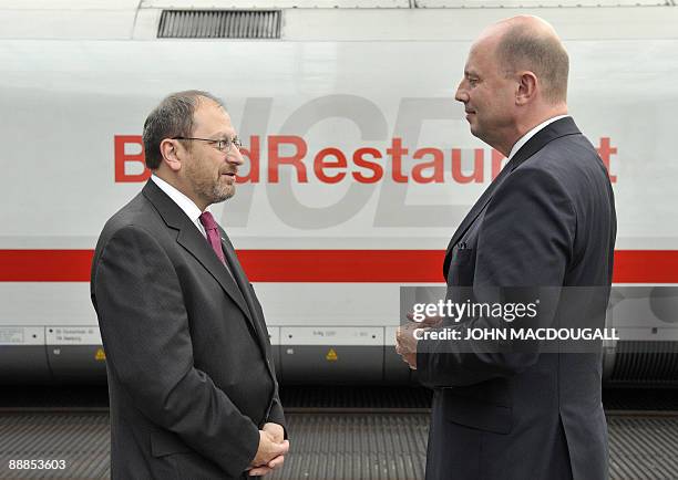 German Transport Minister Wolfgang Tiefensee speaks to the manager of Berlin's central railway station, the Hauptbahnhof, Thomas Hesse as an Inter...