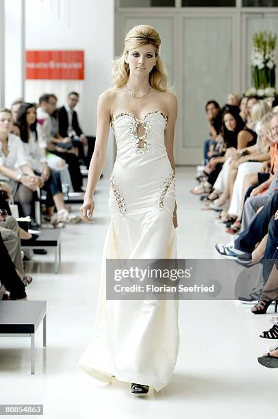 Model walks down the runway at the 'Unrath and Strano Fashion Show' during the Mercedes-Benz Fashion Week Berlin S/S 2010 at Ellington Hotel on July...