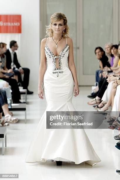 Model walks down the runway at the 'Unrath and Strano Fashion Show' during the Mercedes-Benz Fashion Week Berlin S/S 2010 at Ellington Hotel on July...