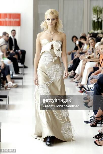 Model walks down the runway at the 'Unrath and Strano Fashion Show' during the Mercedes-Benz Fashion Week Berlin S/S 2010 at Ellington Hotel on July...