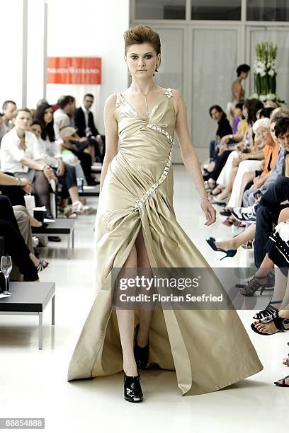 Model walks down the runway at the 'Unrath and Strano Fashion Show' during the Mercedes-Benz Fashion Week Berlin S/S 2010 at Ellington Hotel on July...