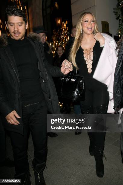 Bryan Tanaka and singer Mariah Carey are seen leaving the Royal Monceau hotel on December 8, 2017 in Paris, France.
