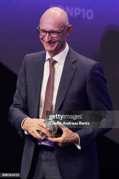 Deutsche Telekom CEO Timotheus Hoettges poses with his award during the German Sustainability Award at Maritim Hotel on December 8, 2017 in...