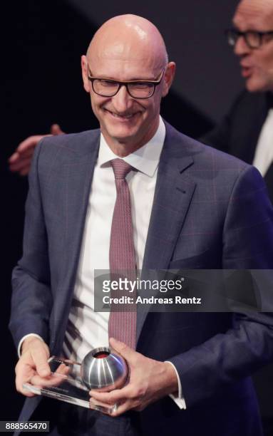 Deutsche Telekom CEO Timotheus Hoettges poses with his award during the German Sustainability Award at Maritim Hotel on December 8, 2017 in...