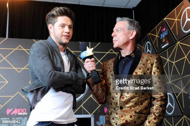 Niall Horan and Elvis Duran attend the Z100's Jingle Ball 2017 backstage on December 8, 2017 in New York City.