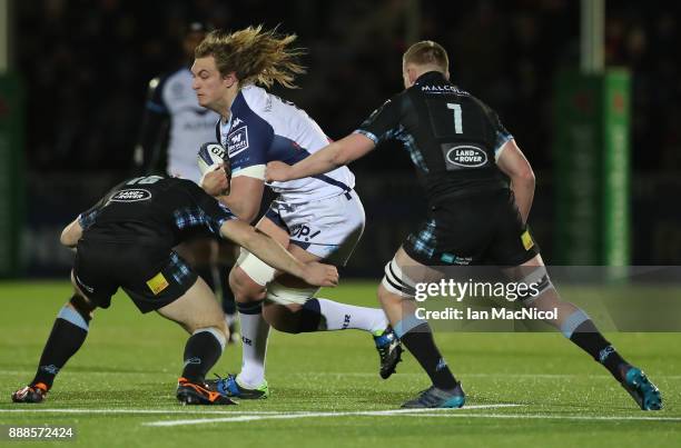 James Malcolm of Glasgow Warriors tackles Jacques Du Plessis of Montpellier during the European Rugby Champions Cup match between Glasgow Warriors...