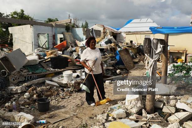 Flo Webber stands amongst the debris of her home on the nearly destroyed island of Barbuda on December 8, 2017 in Cordington, Barbuda. Barbuda, which...