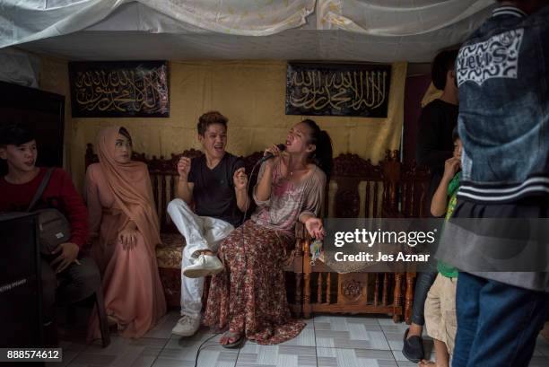 Nassif Malang and Nicole Pangkan sing and have fun inside their house on October 21, 2017 in Saguiaran, southern Philippines. Nassif began taking in...