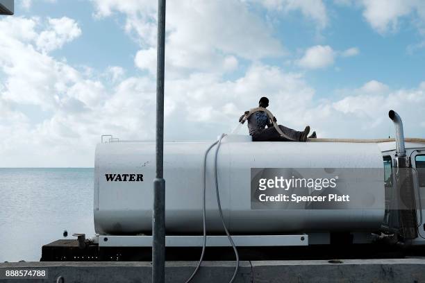 Man working for the charity Samaritan's Purse works on a desalination truck on the nearly destroyed island of Barbuda on December 8, 2017 in...