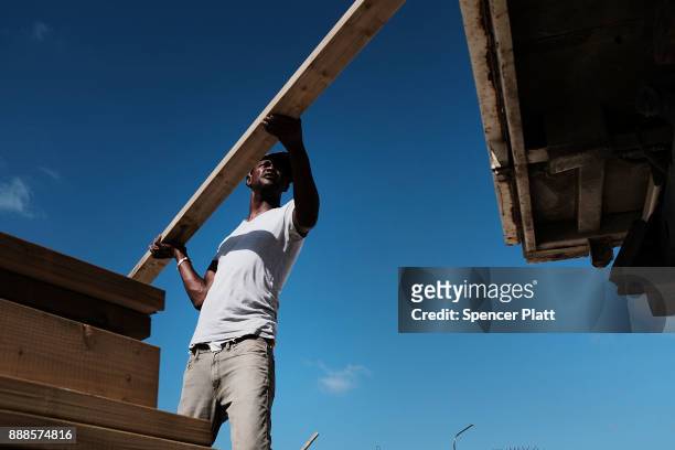 Truck is loaded with plywood on the nearly destroyed island of Barbuda on December 8, 2017 in Cordington, Barbuda. Barbuda, which covers only 62...