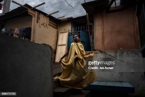 Abnaim Malud a gay resident of Marawi tries on a curtain to serve as a gown on October 20, 2017 in Saguiaran, southern Philippines. Abnaim now lives...