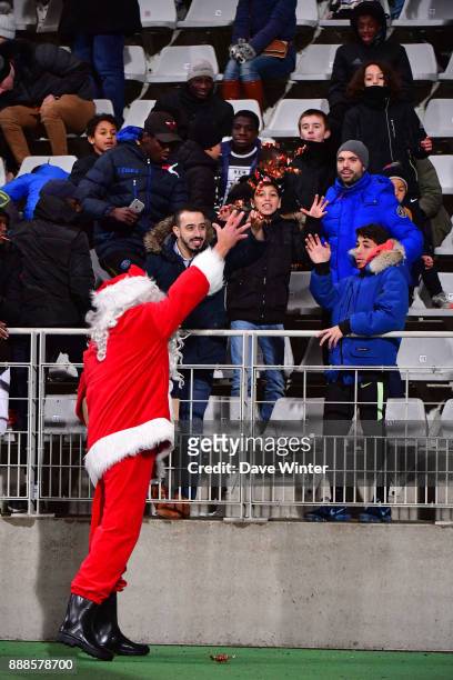 Father Christmas distributing sweets at half-time during the Ligue 2 match between Paris FC and RC Lens at Stade Charlety on December 8, 2017 in...