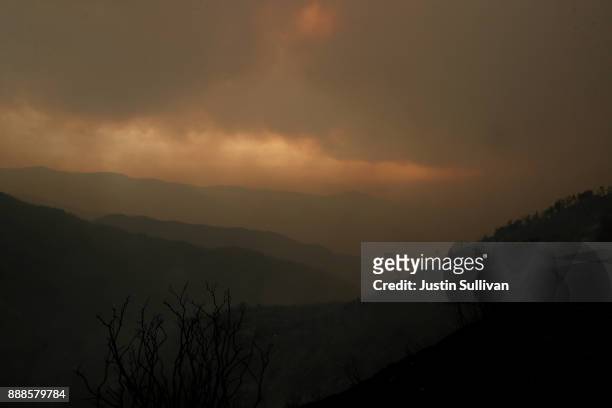 Smoke from the Thomas fire bhangs over the Los Padres National Forest on December 8, 2017 near Ojai, California. The Thomas fire has burned over...