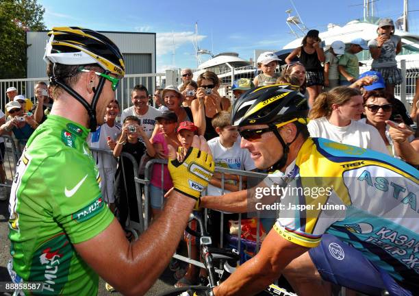 Stage winner Mark Cavendish of Great Britain and Team Columbia HTC gets congratulated by Lance Armstrong of USA and team Astana as he celebrates his...