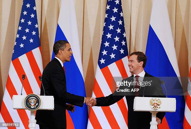 Russian President Dmitry Medvedev shakes hands with US President Barack Obama during a press briefing at the Kremlin in Moscow on July 6, 2009 after...