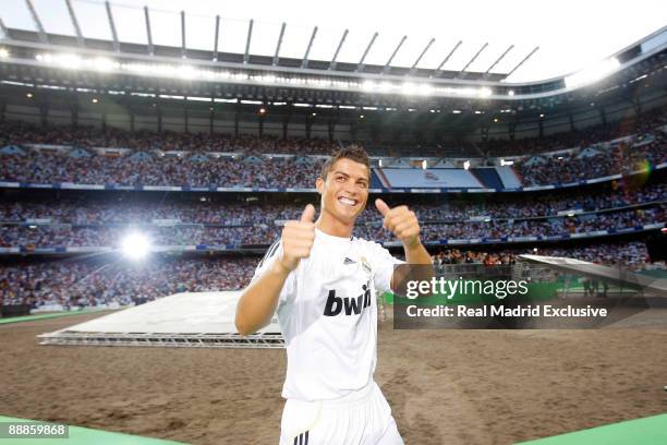 Cristiano Ronaldo waves to fans during his official presentation as new Real Madrid Player, at the Santiago Bernabeu Stadium on July 6, 2009 in...