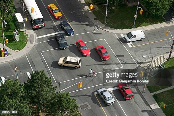 aerial view of traffic in intersection - road intersection stock pictures, royalty-free photos & images