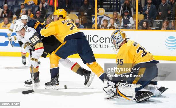 Pekka Rinne of the Nashville Predators makes the save against Tomas Nosek of the Vegas Golden Knights as Anthony Bitetto defends during an NHL game...