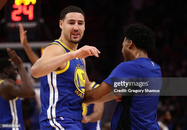 Klay Thompson of the Golden State Warriors celebrates a second half three point basket while playing the Detroit Pistons at Little Caesars Arena on...