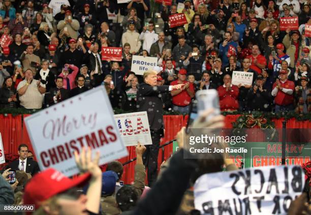 President Donald Trump waves as fake snow falls as he ends a rally at the Pensacola Bay Center on December 8, 2017 in Pensacola, Florida. Mr. Trump...