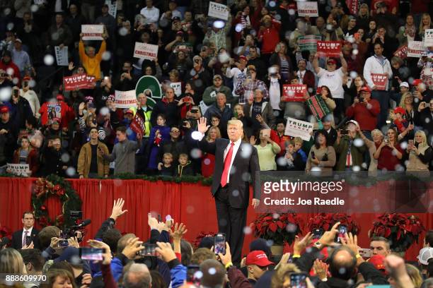 President Donald Trump waves as fake snow falls as he ends a rally at the Pensacola Bay Center on December 8, 2017 in Pensacola, Florida. Mr. Trump...