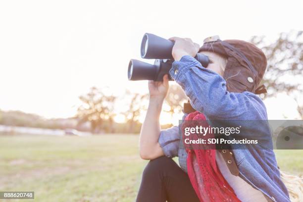 young explorer uses binoculars - superman reveal stock pictures, royalty-free photos & images