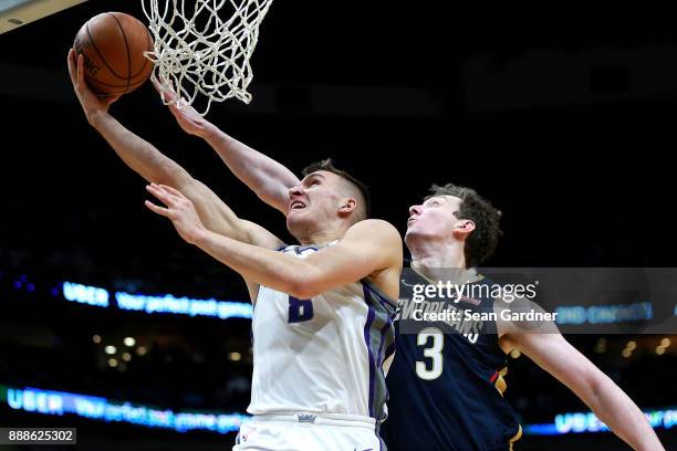 Bogdan Bogdanovic of the Sacramento Kings is fouled by Omer Asik of the New Orleans Pelicans during the second half of a NBA game at the Smoothie...