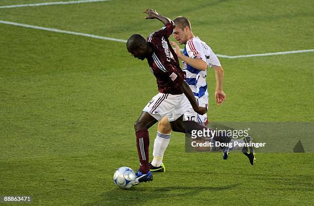 Omar Cummings of the Colorado Rapids tries to control the ball as Kyle Davies of FC Dallas defends during MLS action at Dick's Sporting Goods Park on...